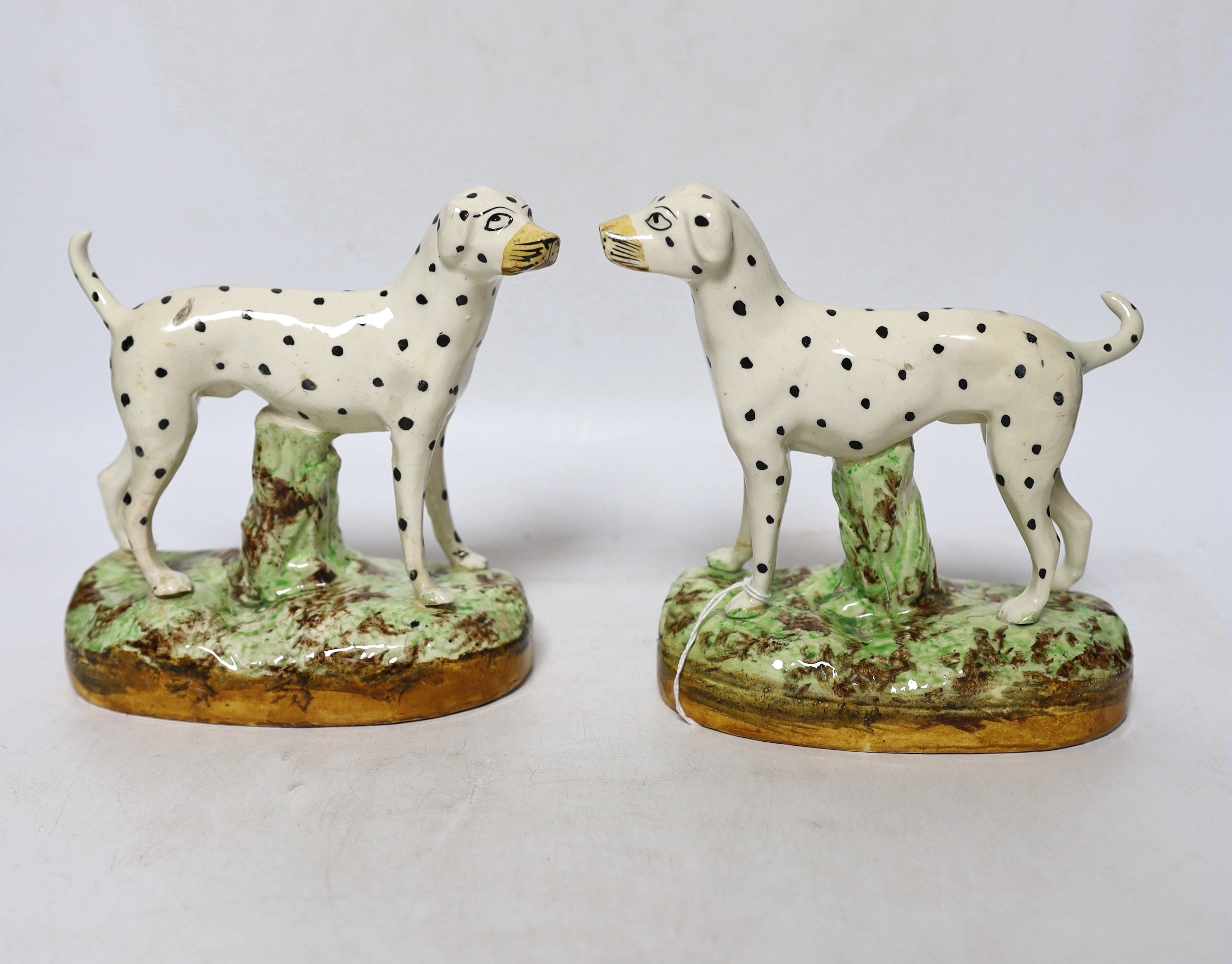 A pair of Staffordshire pottery figures of Dalmatians, 16cm
